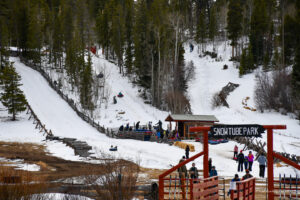 Snow tubing park at Beaver Meadows Resort in Red Feather lakes showing tube lifts and visitors.