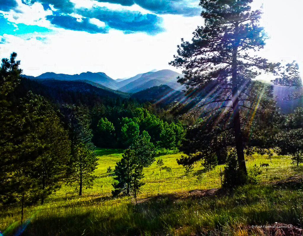 Sun peeking through clouds at dusk near Red Feather Lakes, Colorado