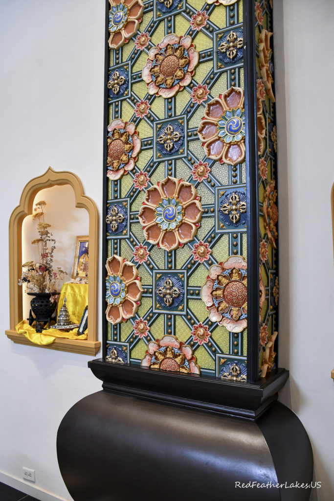 Colorful ornate pillar with floral patterns indoors.
