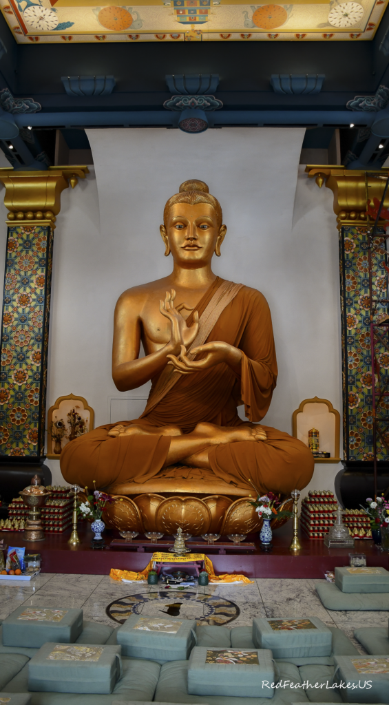 Golden Buddha statue in ornate temple setting