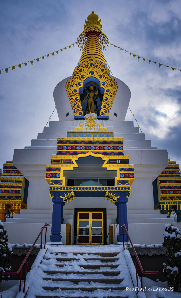 Colorful Buddhist stupa in snowy landscape