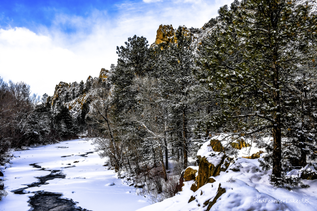 Rock Outcroppings in the Foreground in a Shot of the Scenic Cache La Poudre River