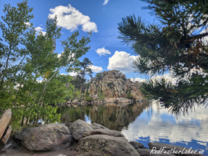 Serene scene at Bellaire Lake with rocks and trees