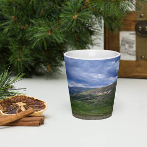 Mountain landscape printed ceramic cup on table