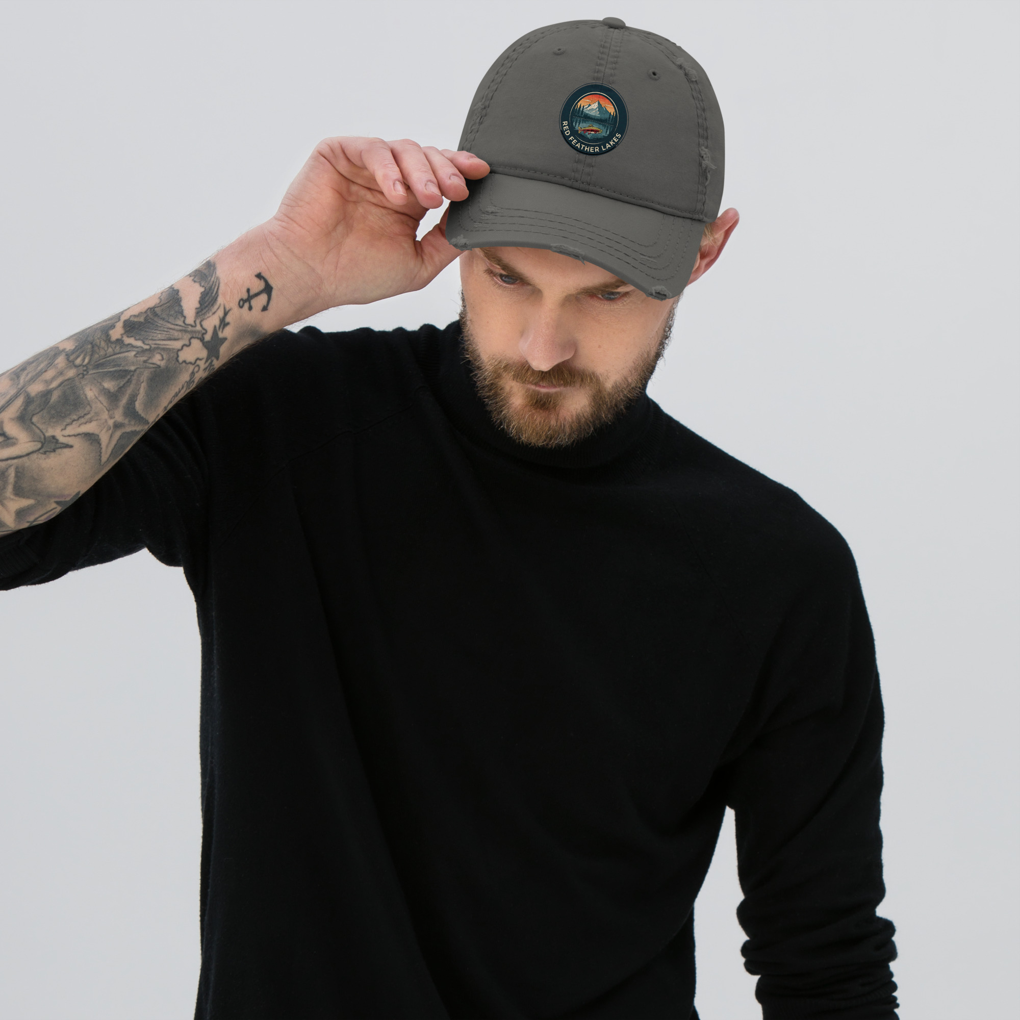 Man adjusting gray baseball cap with logo