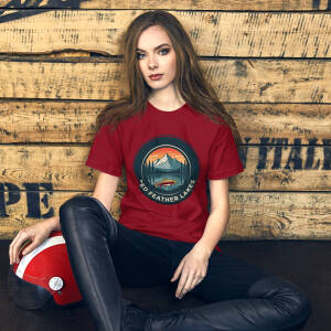 Woman in red graphic T-shirt sitting indoors