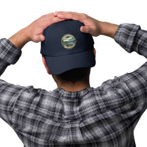 Man adjusting navy cap with lake emblem