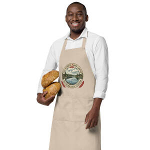 Smiling baker holding two artisan bread loaves