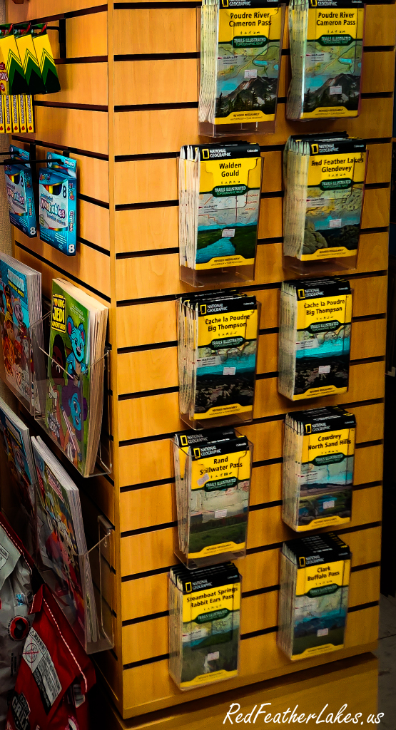 A rack of National Geographic topographic maps of the Poudre Canyon and Red Feather Lakes at the Trading Post Resort store