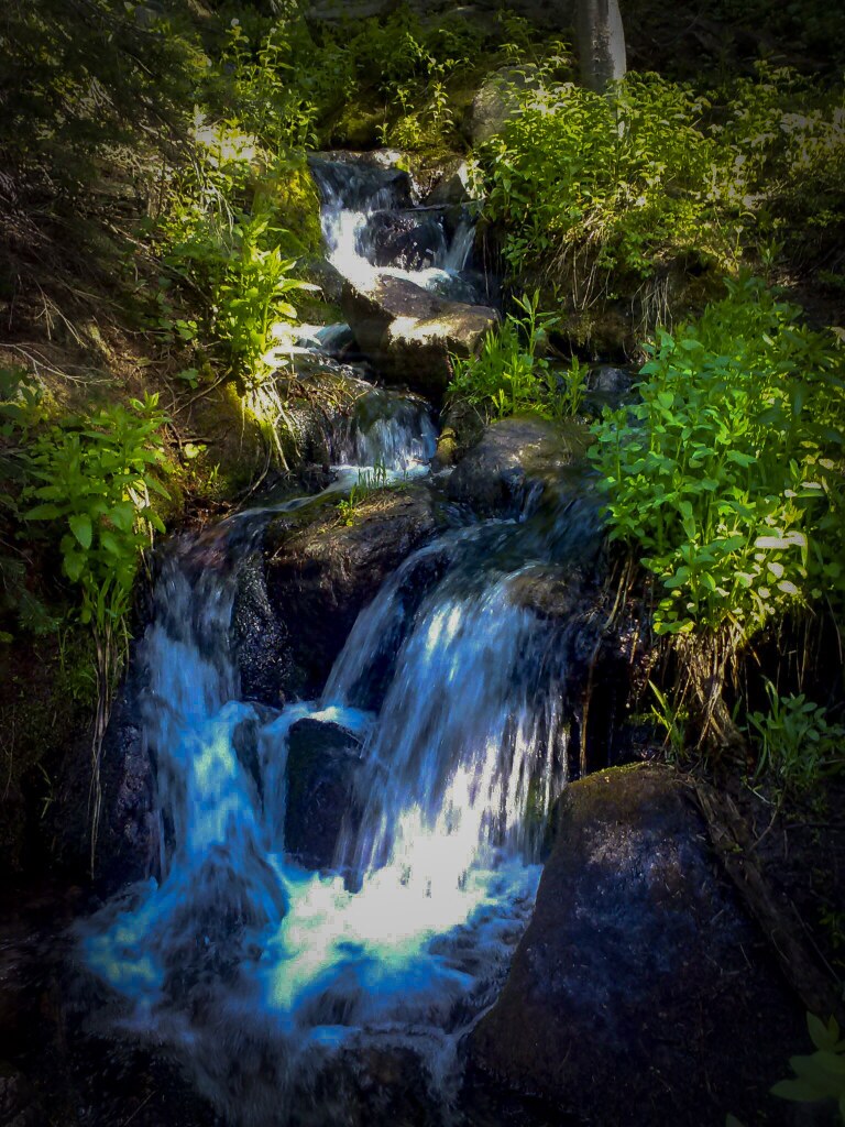 A short cascade of snowmelt tumbling over rock beside the path to Dream Lake, Rocky Mountain National Park