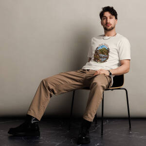Bone-colored unisex t-shirt with artwork reading Say Less, Live More over a Cache la Poudre canyon river framed by pine