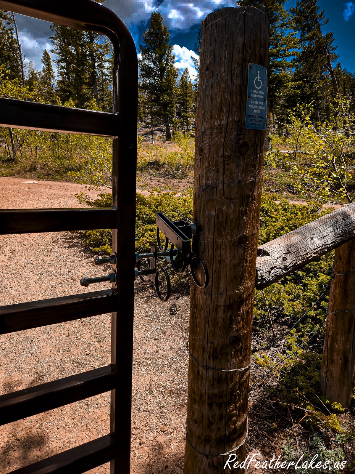 An accessible metal gate with a wheelchair-friendly latch on the Granite Ridge West / Molly Lake Trail